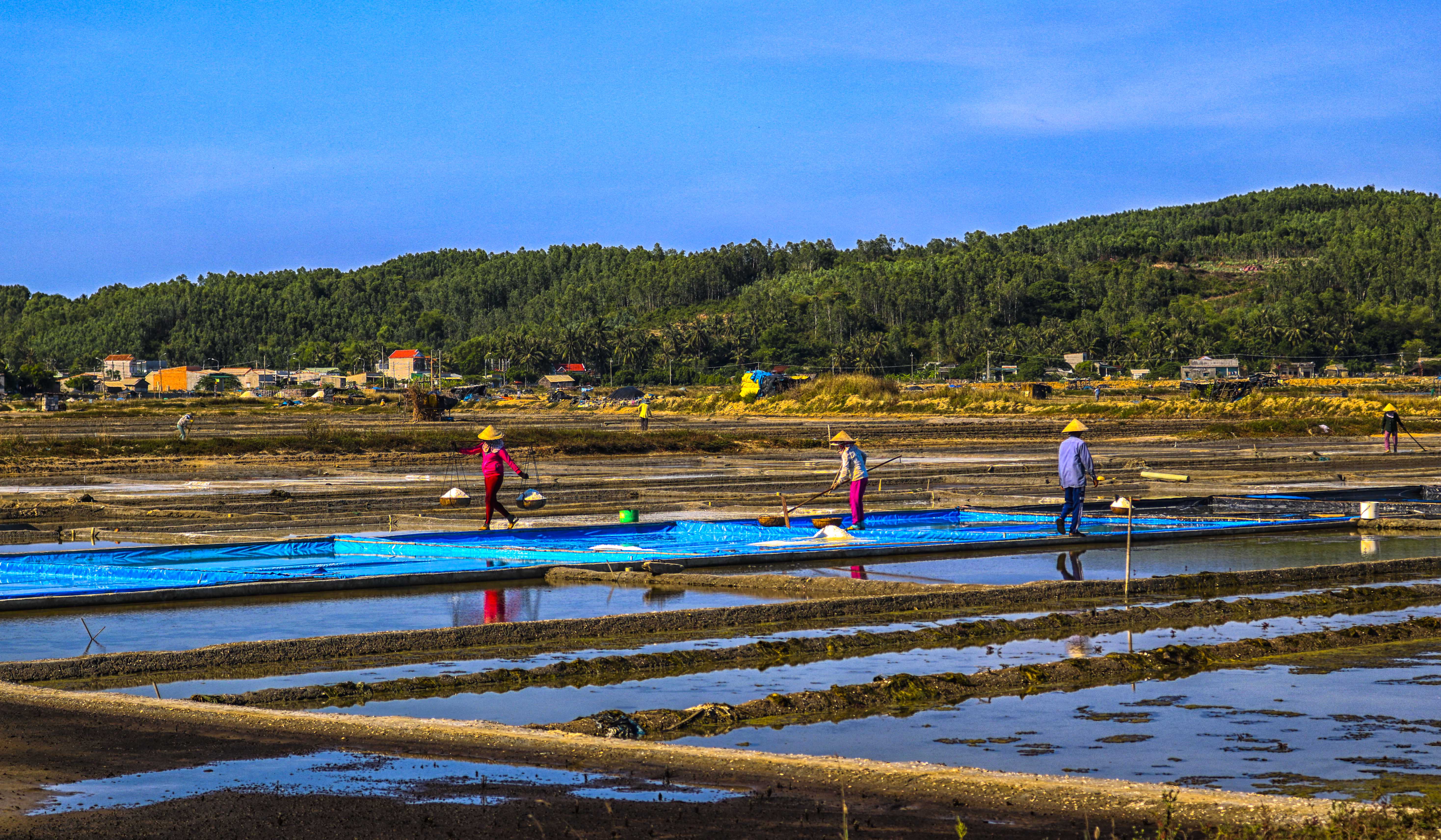 Salt farmers still keep traditional salt production method.