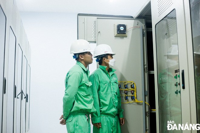 Workers are seen checking equipment and machines at the station.