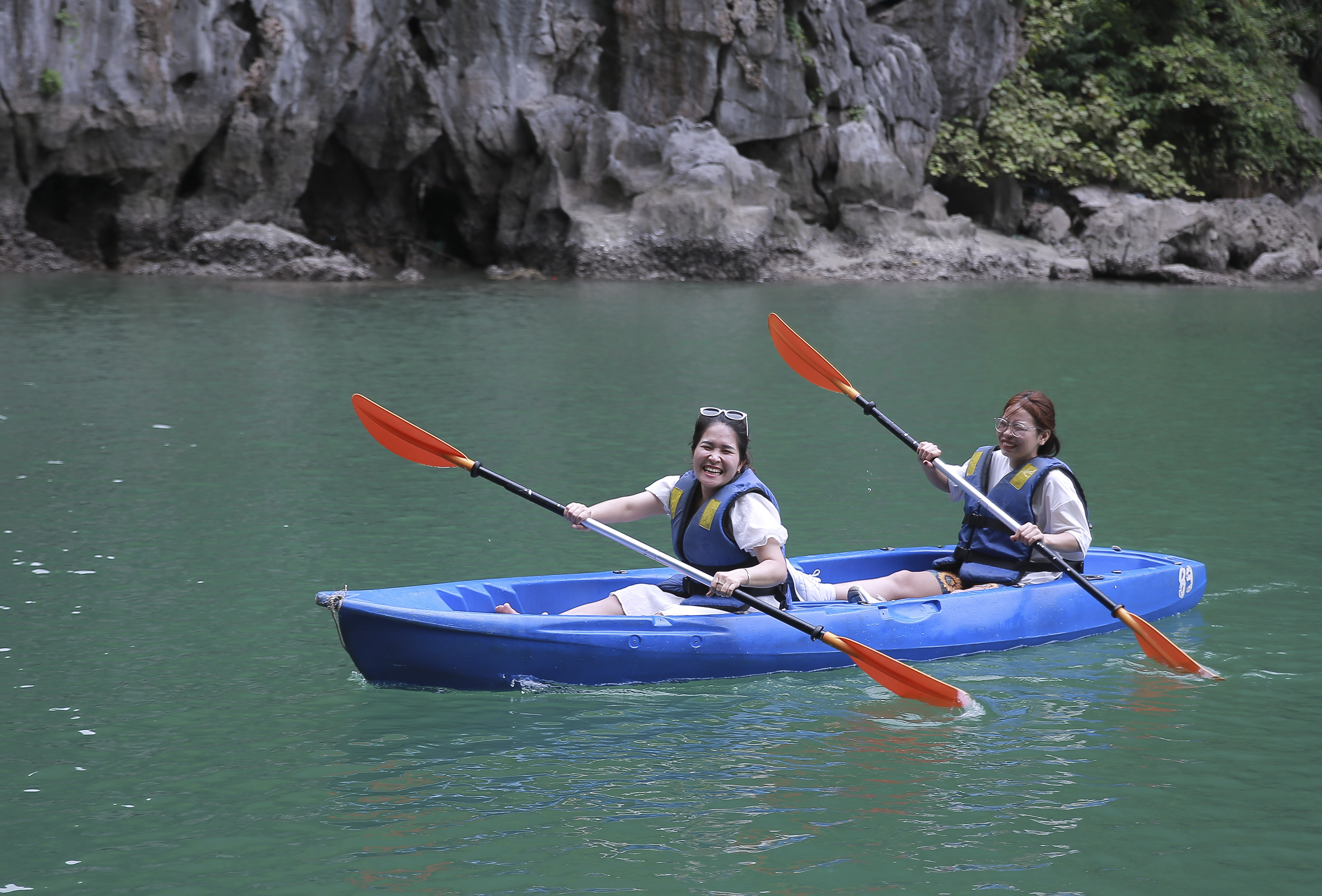 Visitors go kayaking to explore Luon Cave.