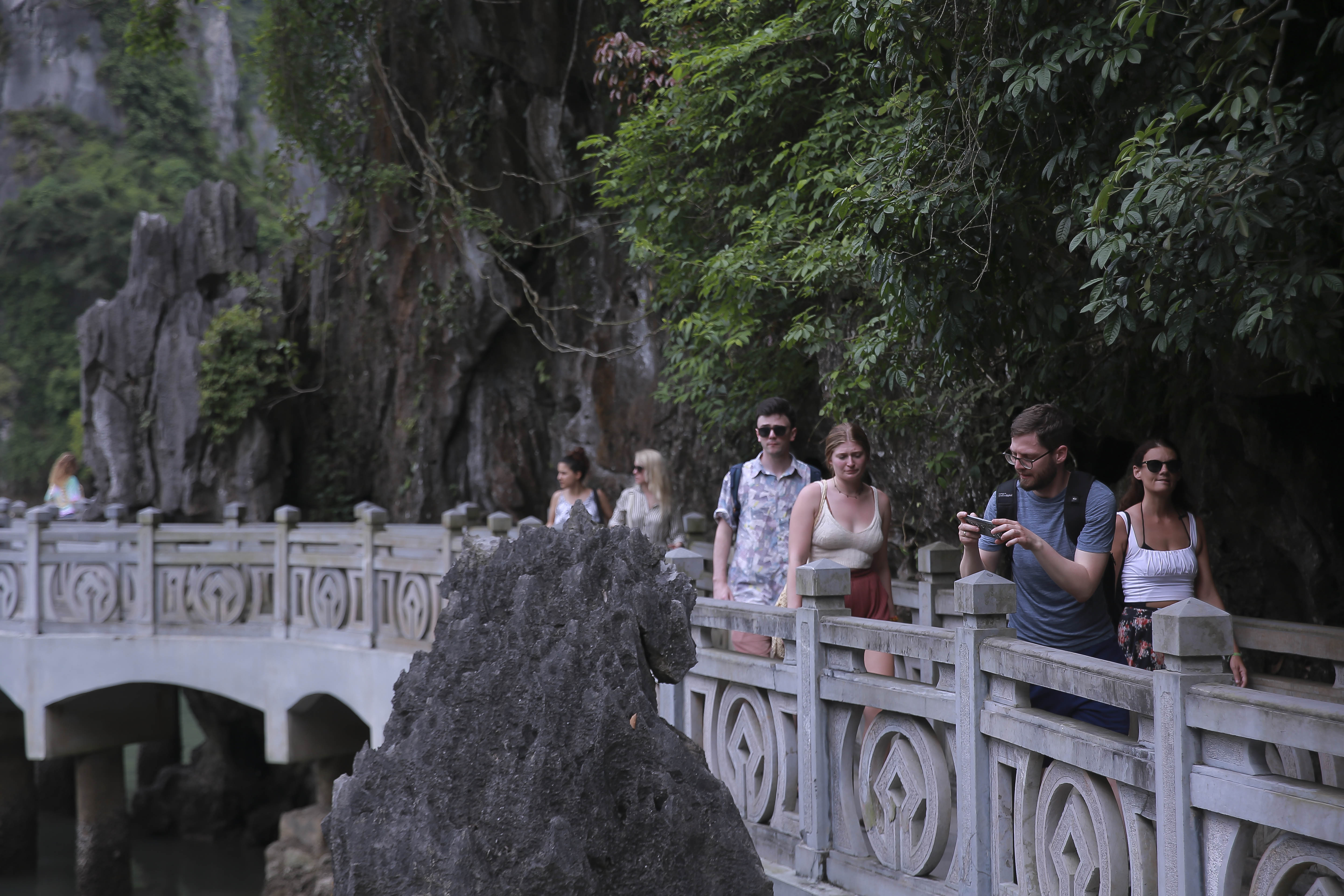 A delegation of international tourists are seen exploring Ha Long Bay.