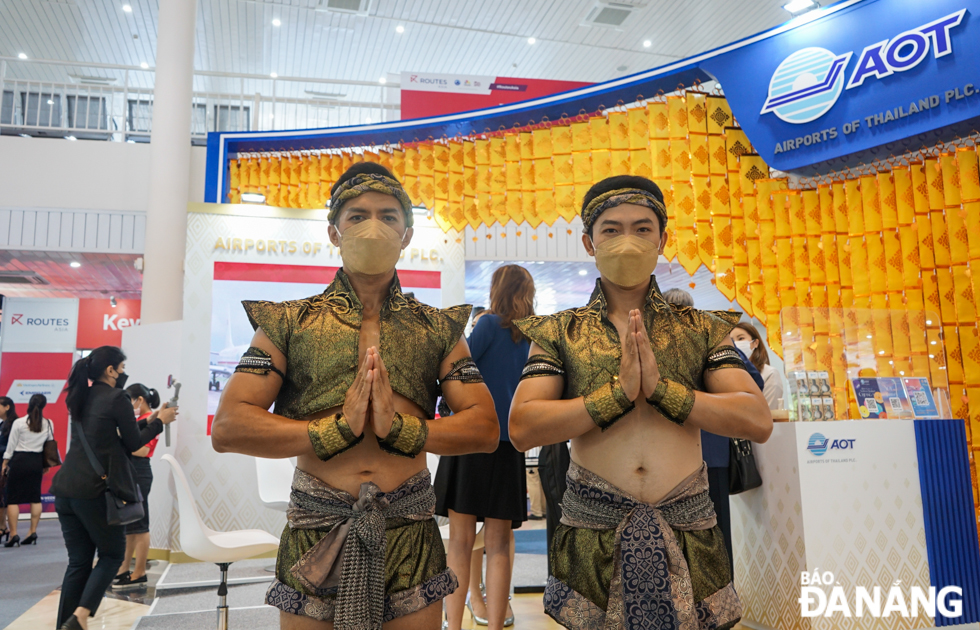 Airports of Thailand's pavilion builds an image with the typical golden tones of 'the land of the Golden Pagodas'. Thai tourism staff getting dressed in traditional Muay Thai costumes.