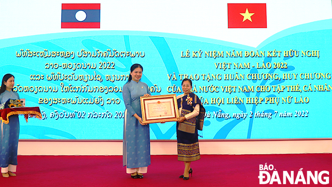 Chủ tịch Hội LHPN Việt Nam Hà Thị Nga trao Huân chương Độc lập hạng Ba của Nhà nước Việt Nam cho lãnh đạo Hội Liên hiệp Phụ nữ Lào. Ảnh: HUỲNH TRANG