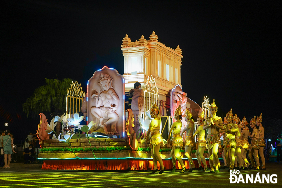 The parade vehicle with the image of a municipal-level historical site - the Museum of Cham Sculpture, and a group of dancers in traditional Cham costumes.