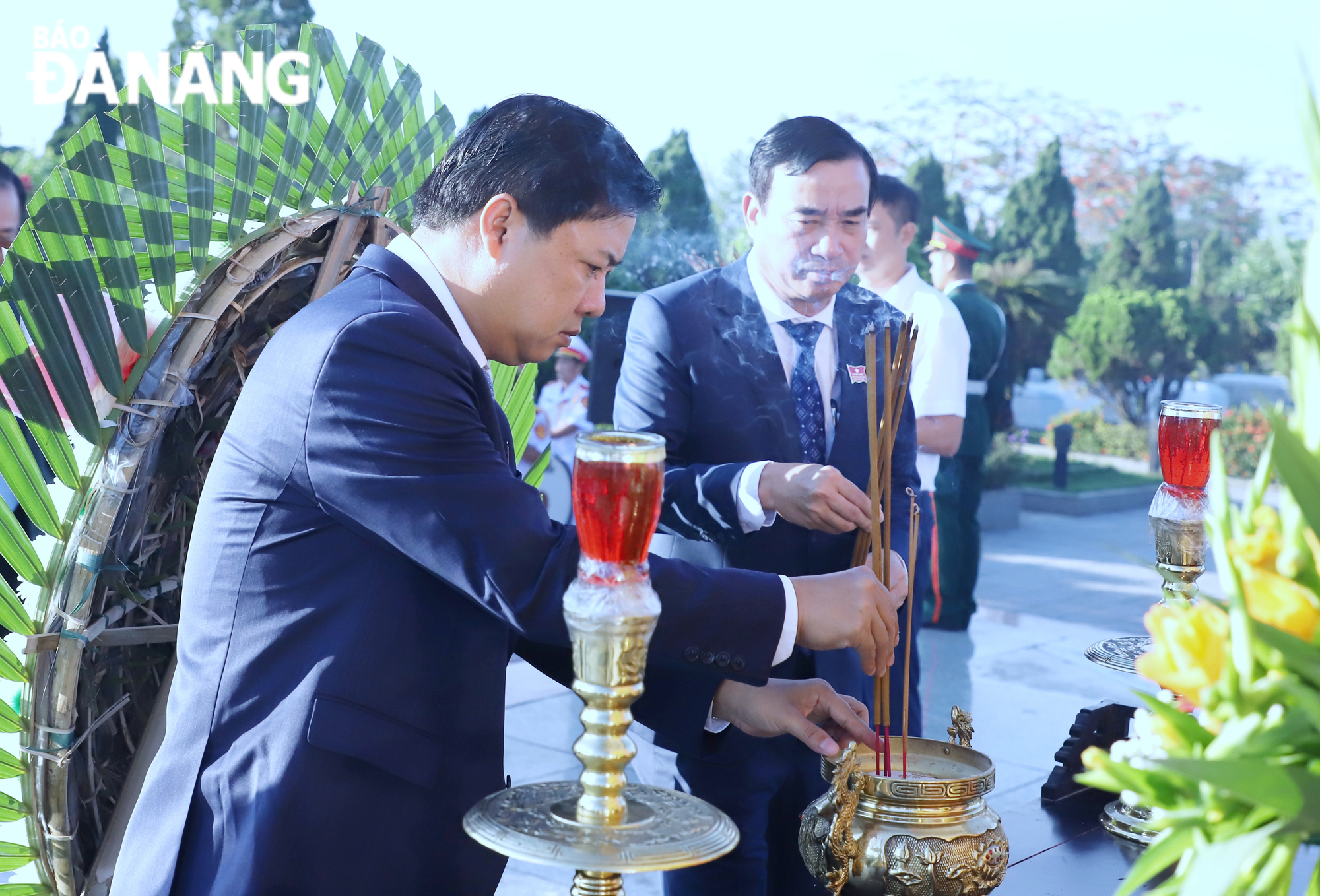 Mr Luong Nguyen Minh Triet, the Deputy Secretary of the muncipal  Party Committee and Chairman of the municipal Peoples Council (left) and Mr Le Trung Chinh, the Chairman of the municipal Peoples Committee burning incense at the City’s Martyrs Cemetery. Photo: NGOC PHU