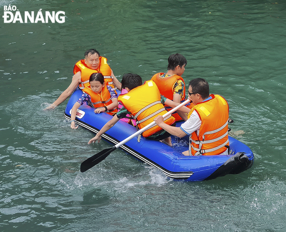 A group of visitors is seen paddling the kayak at Nuoc Mooc Stream