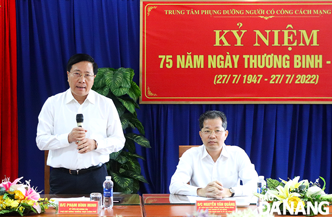 Permanent Deputy Prime Minister Pham Binh Minh (left) speaking during his visit to the Care Center for Revolution Contributors 