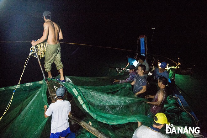 Fishermen together conducting fishing activities in the middle of the night