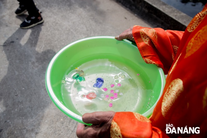  A bowl of water taken from the sea are brought to the shore by fishermen to perform rituals for peace.