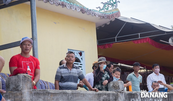 Many locals observe the activities at the festival.