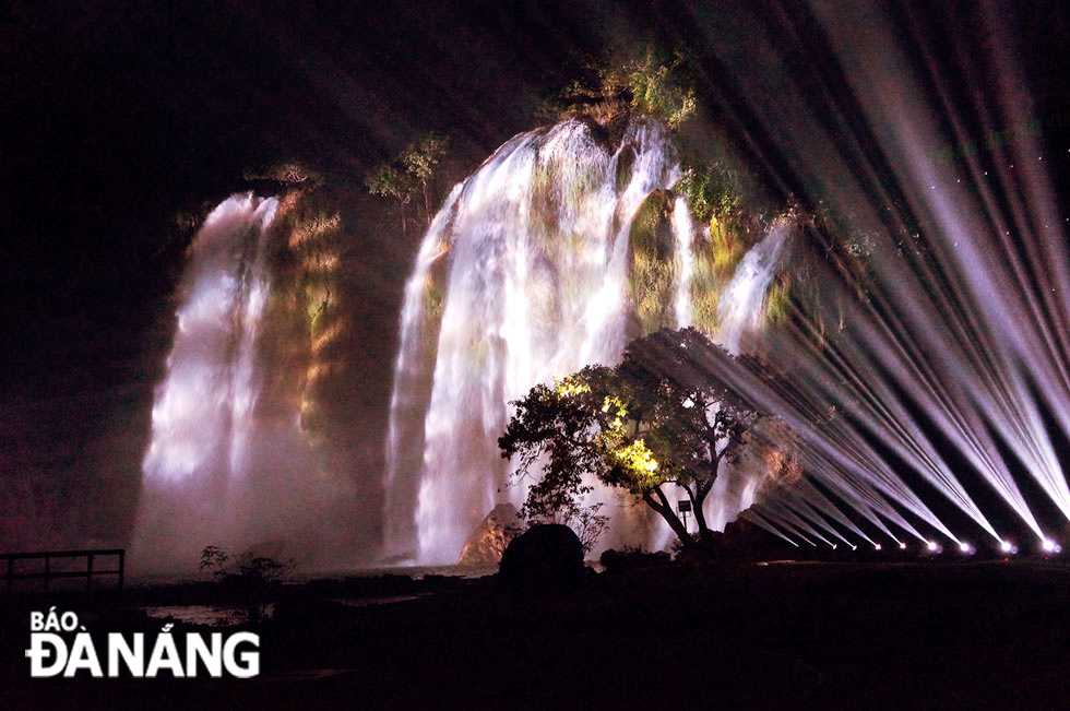 The waterfall lit up by light shows