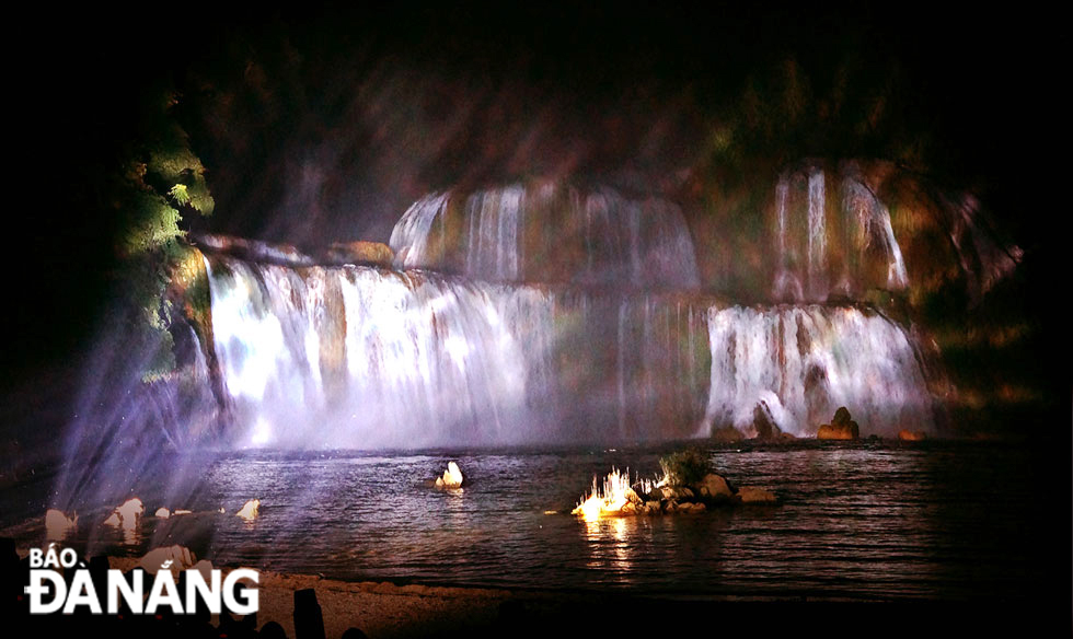 The cascading curtain of water looks particularly magical at night.