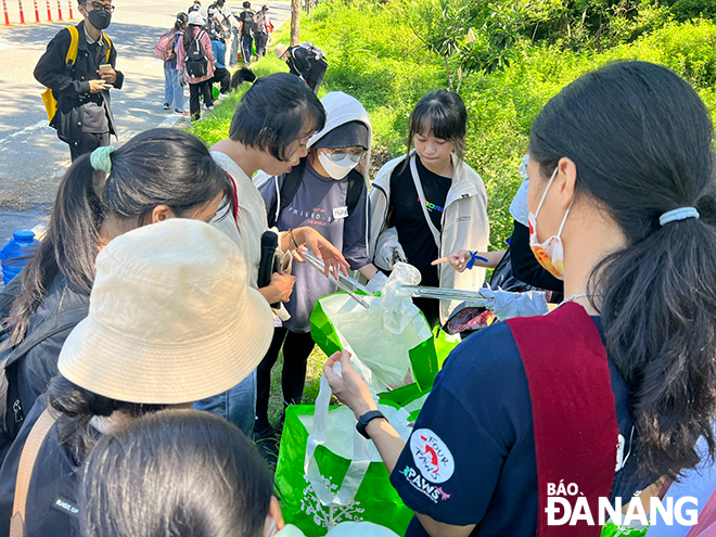 Young people are taught how to sort plastic waste whilst collecting trash 