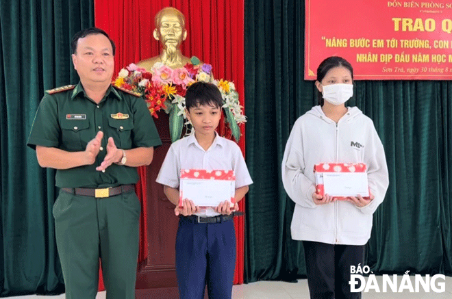 Colonel Do Van Dong, the Secretary of the Party Committee Organisation and Political Commissar of the Da Nang Border Guard Command presenting gifts to disadvantaged children.