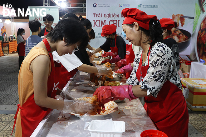 Festival-goers experience how to make Korean kimchi at the festival