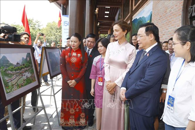 Chủ tịch Quốc hội Vương Đình Huệ, Tổng Giám đốc UNESCO Audrey Azoulay và đại biểu tham quan triển lãm ảnh về di sản thế giới tại Lễ kỷ niệm. Ảnh: Doãn Tấn/TTXVN