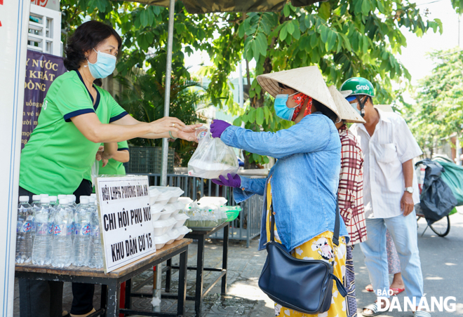 At 10:30am, the lunch portions are given to those in need. Photo: TRUONG KY