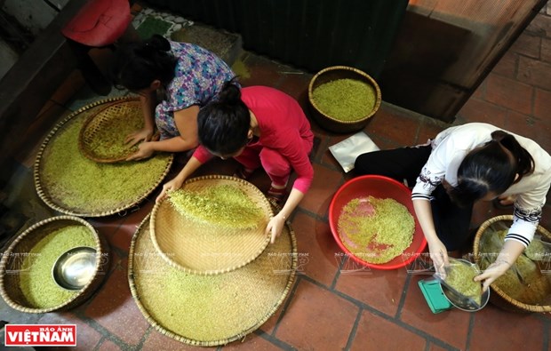 Removing the bran layer and germs to have clean com in Me Tri village, Tu Liem (Photo: VNA)