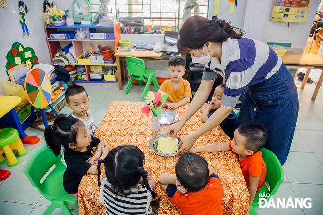 A teacher at the Hoa Bac Preschool preparing lunch for her pupils
