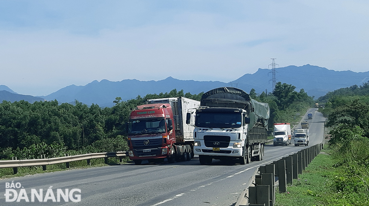 Long-distance vehicles are pictured passing through the city. Photo: THANH LAN