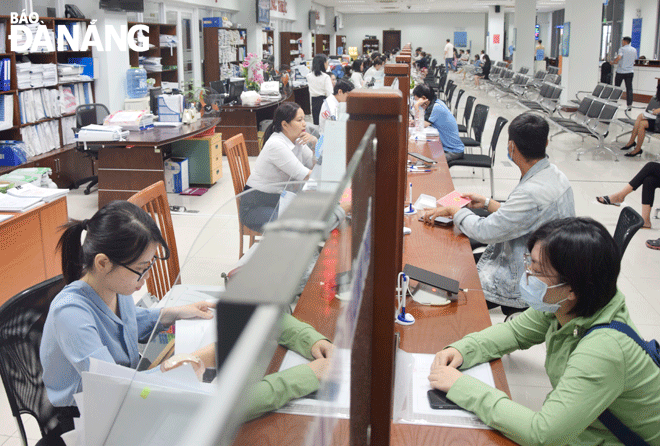 People are seen making transactions at the 'One-stop-shop' department of the Da Nang Administrative Centre