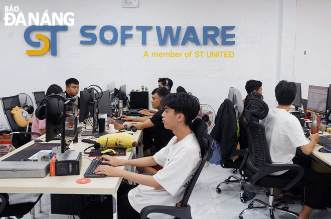 Employees are seen working at the city-based ST Software Joint Stock Company. Photo: MINH LE