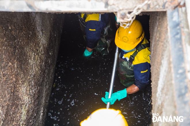 Team of workers immersed themselves in the water to treat trash.