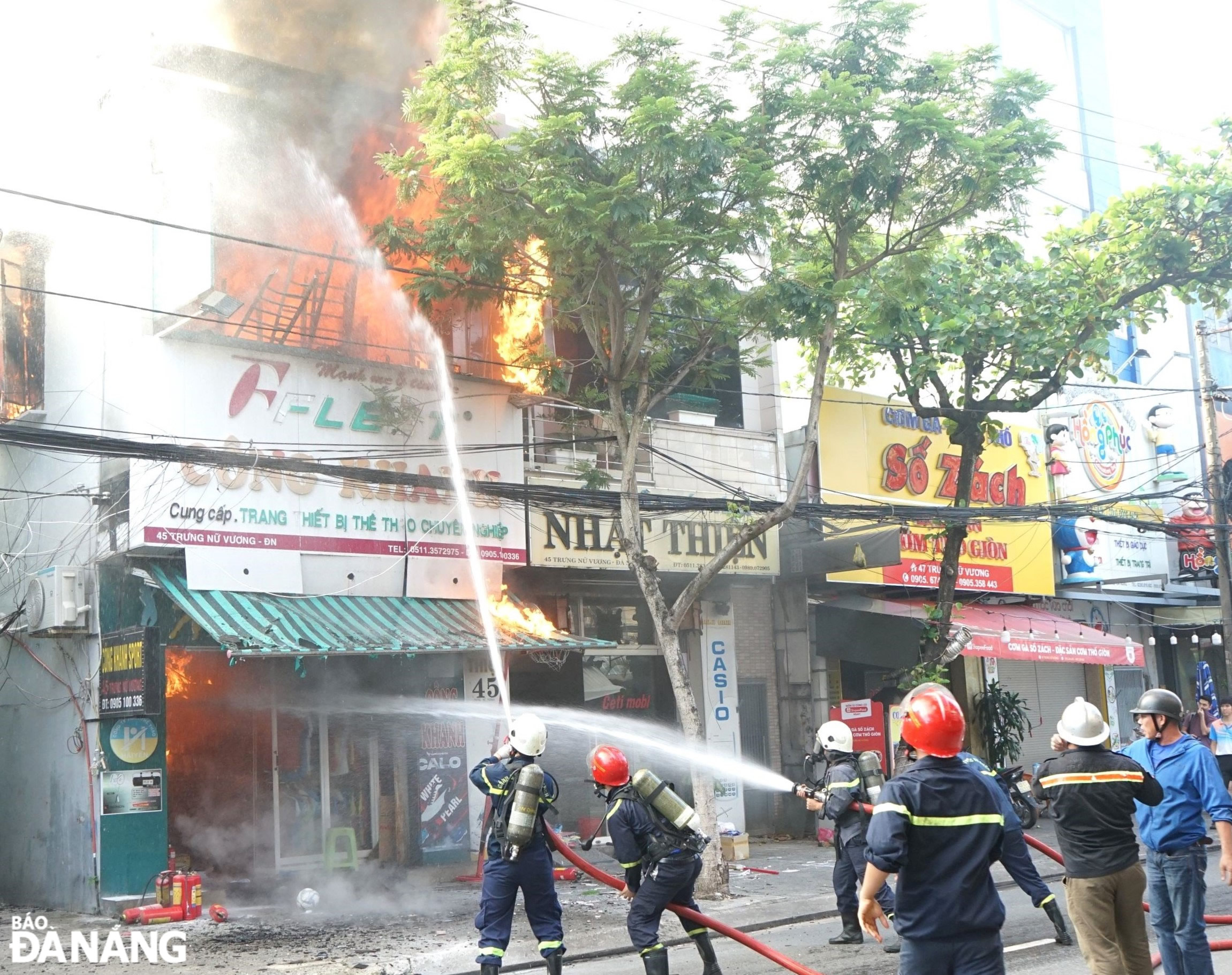 Lực lượng PCCC và CNCH Công an quận Hải Châu tích cực dập tắt ngọn lửa tại cửa hàng bán đồ thể thao. Ảnh: L.H