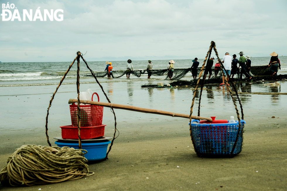 Fishermen are observed pulling fishing net on the beach