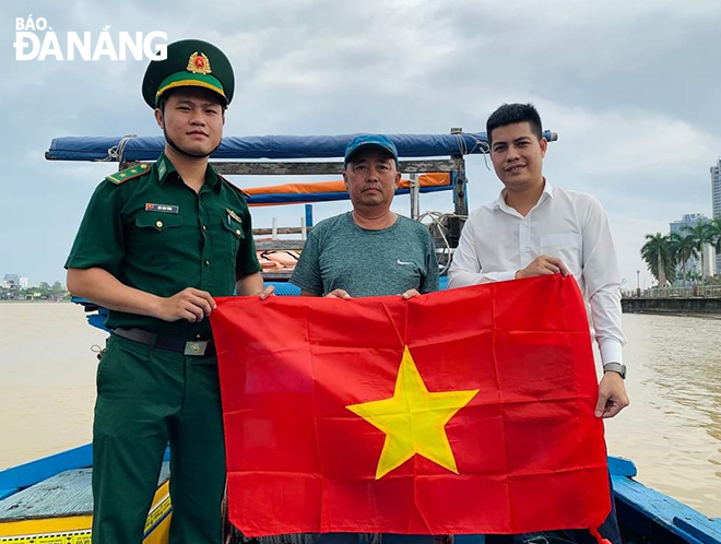 National flags are given to fishermen in a bid to encourage them to continue going out to sea for fishing trips with peace of mind. Photo: HONG QUANG