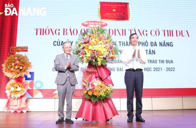 Chairman of the Da Nang People's Committee Le Trung Chinh (right) presenting flowers to congratulate the Duy Tan University on the occasion of its 28th birthday. Photo NGOC HA