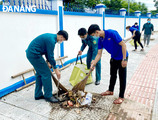 UBND phường Hòa Khánh Bắc huy động lực lượng tham gia dọn vệ sinh môi trường, diệt lăng quăng, bọ gậy phòng, chống sốt xuất huyết. Ảnh: H.L