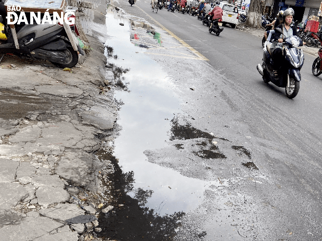 Nước thải tràn lên mặt đường gây ô nhiễm môi trường tại tuyến đường Hoàng Diệu. Ảnh: GIAO THỦY