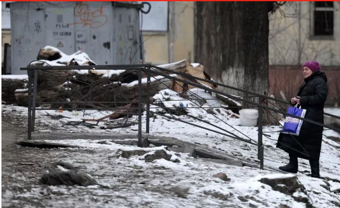 Một người phụ nữ bước đi bên ngoài các tòa nhà bị hư hại tại Vyshhorod, Ukraine. Ảnh: Getty Images