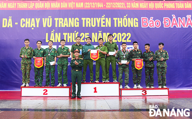 A representative from the organising board presenting awards to outstanding runners in the category of local millitary forces