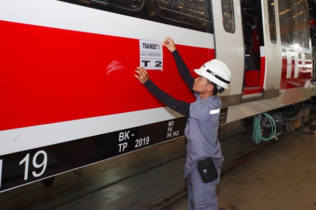 A rail worker places a sign on an LRT Jabodebek train car, made by state-owned train manufacturer PT Industri Kerata Api (INKA). (Photo: thejakartapost.com)