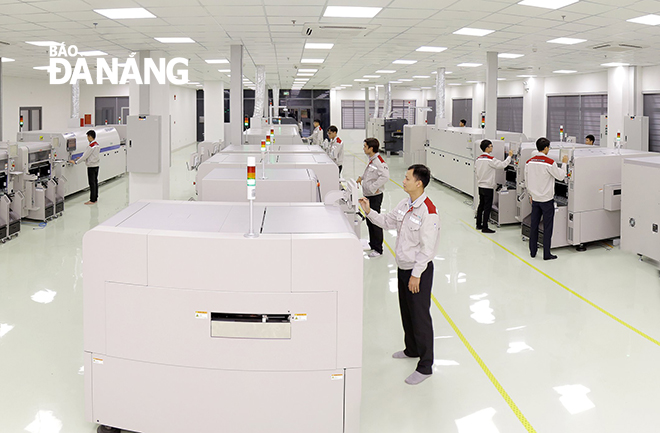 Engineers working at the SMT high-tech electronics manufacturing and assembly factory located in the Da Nang Hi-Tech Park.