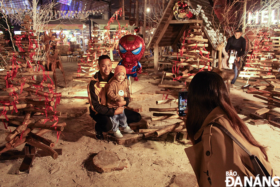 A family posing for a New Year photo at the Helio Night Market