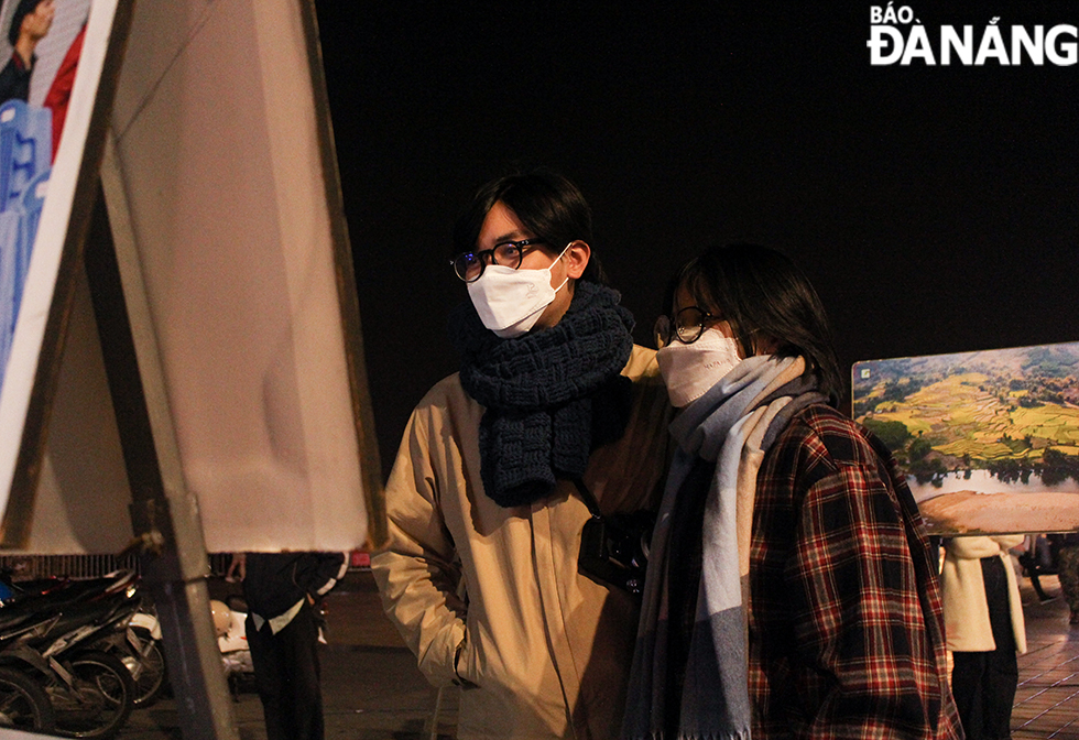 Visitors at a photo exhibition along Bach Dang Street