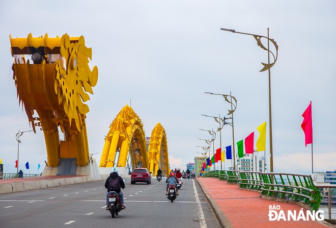 The Rong (Dragon) Bridge is decorated colorfully with flags and flowers in the first day of the New Year.