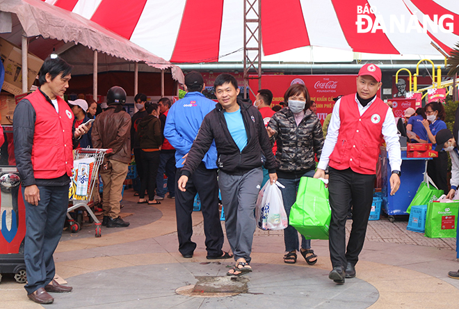 People use vouchers to buy food and household appliances at the 'Mobile Supermarket'