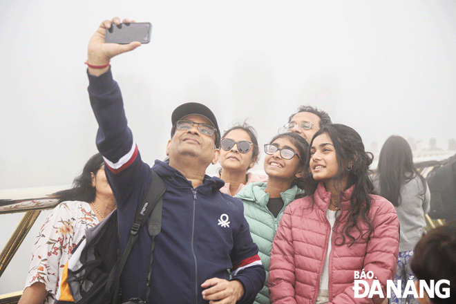 Foreigners have fun at the Sun World Ba Na Hills Tourist Area. Photo: THU HA