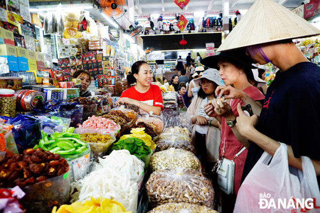 Visitors experience a stall selling cakes, sweets and jams. Photo: K.T