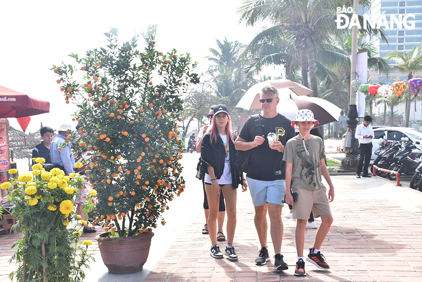 Tourists are seen going for a stroll along Da Nang beaches. Photo: THU HA