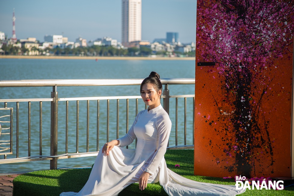 A pretty girl in graceful 'ao dai' on Bach Dang Street.