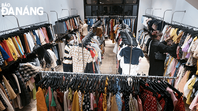 . Spacious shopping space helps customers to freely choose clothes at the Give Away store.