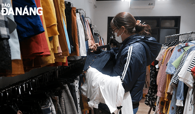 A female shopper picks up favourate clothes for Tet.