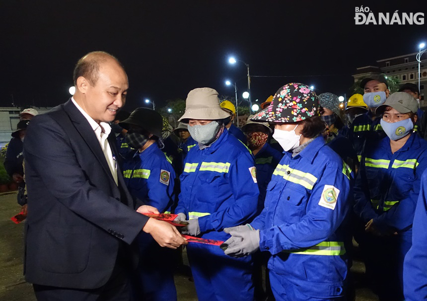 Phó Chủ tịch UBND thành phố Lê Quang Nam lì xì cho công nhân Công ty CP Môi trường đô thị Đà Nẵng. Ảnh: HOÀNG HIỆP