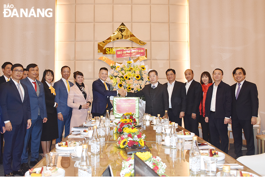 Bí thư Thành ủy Nguyễn Văn Quảng (thứ 6 từ phải sang) làm trưởng đoàn đến thăm, chúc tết Công ty CP Tập đoàn Mặt Trời. Ảnh: THU HÀ