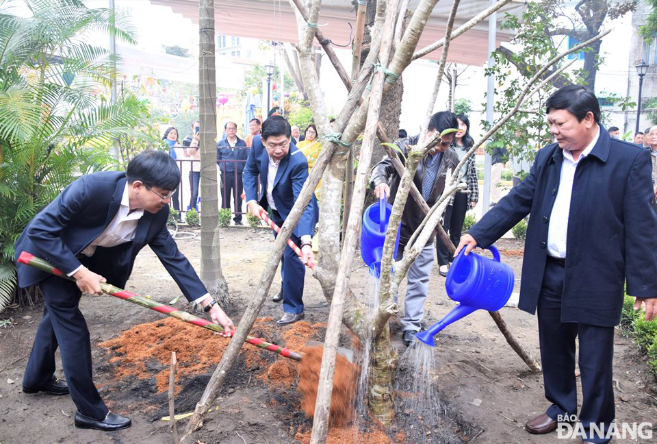 Bí thư Quận ủy Hải Châu Trần Thắng Lợi (bìa trái) cùng lãnh đạo UBND quận Hải Châu trồng cây đầu xuân tại Đình làng Hải Châu. Ảnh: TRỌNG HUY