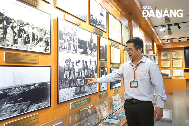 Mr Cong at the exhibition space of images and documents proving Viet Nam's legal sovereignty over the Hoang Sa Archipelago. Photo: XUAN SON